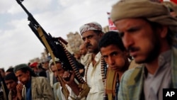 FILE - Shiite Houthi rebels attend a rally to protest Saudi-led airstrikes, in Sanaa, Yemen, in August 2015. 