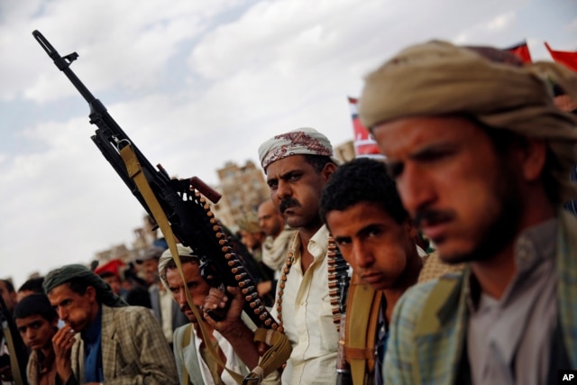 FILE - A Shiite Houthi rebel holds his weapon as he attends a rally to protest Saudi-led airstrikes, in Sanaa, Yemen, Aug. 24, 2015.