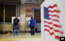 Voters cast ballots in Georgia's primary election at a polling site in a firehouse in Atlanta, Georgia, March 1, 2016.