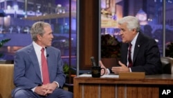 FILE - This Nov. 19, 2013 photo released by NBC shows former President George W. Bush, left, with host Jay Leno during "The Tonight Show with Jay Leno," Bush showed off his painting and his granddaughter and poked fun of his post-White House years.