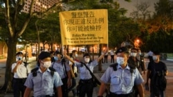 Police officers disperse people mourning at Victoria Park on the 32nd anniversary of the crackdown on pro-democracy demonstrators at Beijing's Tiananmen Square in 1989, in Hong Kong, China June 4, 2021.