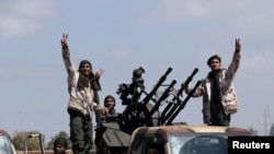 Libyan National Army (LNA) members, commanded by Khalifa Haftar, head out of Benghazi to reinforce the troops advancing to Tripoli, in Benghazi, Libya, Apr. 7, 2019. 