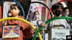 FILE - Human rights groups gather to raise their slogan calling for a boycott of the Beijing Winter Olympics 2022, in Taipei, Taiwan, Jan. 26, 2022.