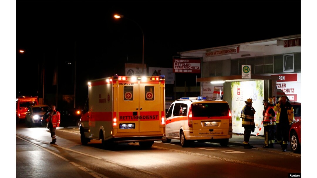 German emergency services workers work in the area where a man with an ax attacked passengers on a train near the city of Wuerzburg, Germany, early July 19, 2016.