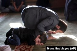 CHECHNYA -- Chechen Muslims pray in a mosque during the Islamic holiday of Eid al-Adha in Chechen regional capital of Grozny, August 21, 2018.