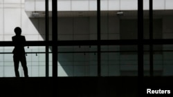 FILE- A woman talks on phone inside the Bank of China head office building in Beijing, China March 30, 2016. Chinese women are increasingly putting careers ahead of marriage, data shows.