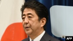 Japanese Prime Minister Shinzo Abe delivers a war anniversary statement that neighboring nations will scrutinize for signs of sufficient remorse over Tokyo's past militarism at his official residence in Tokyo, August 14, 2015. 