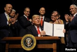 U.S. President Donald Trump is applauded after signing an Executive Order on U.S.-Cuba policy at the Manuel Artime Theater in Miami, Florida, June 16, 2017.