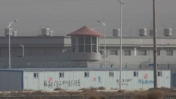 In this Dec. 3, 2018, file photo, a guard tower and barbed wire fences are seen around a facility in the Kunshan Industrial Park in Artux in western China's Xinjiang region.