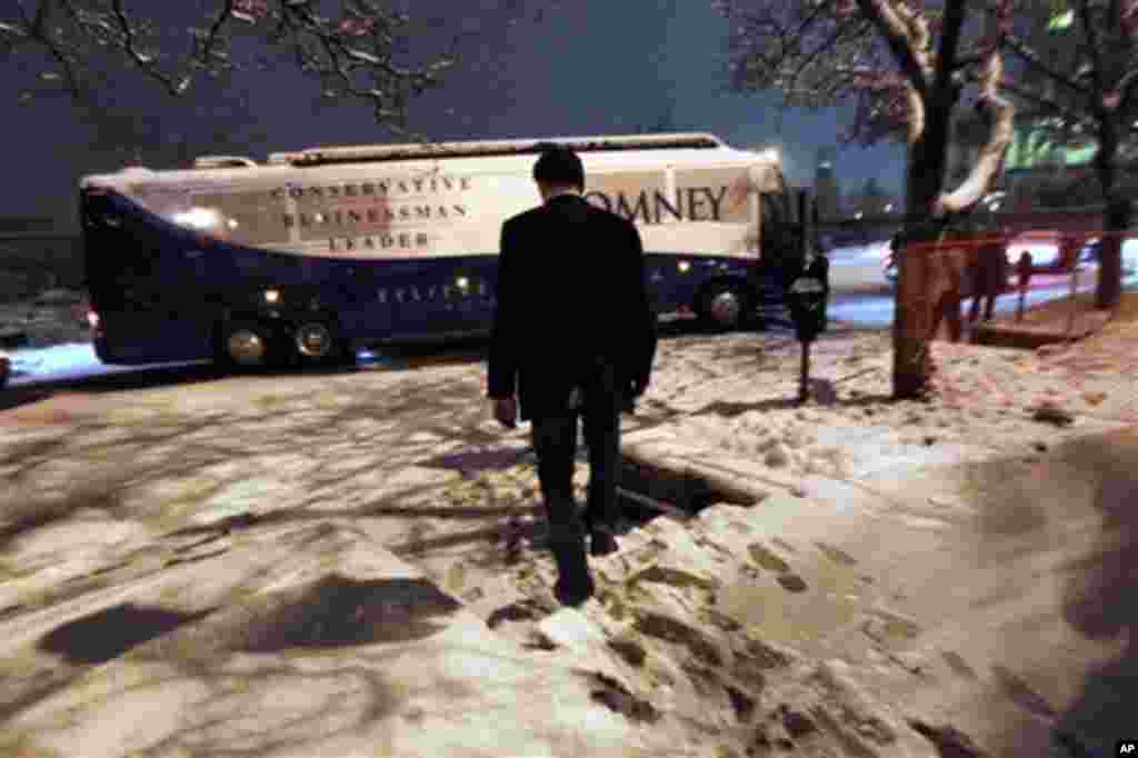 Republican presidential candidate, former Massachusetts Gov. Mitt Romney, walks to his campaign bus after speaking at a town hall meeting in Kalamazoo, Mich., Friday, Feb. 24, 2012.