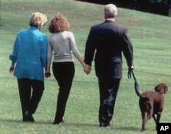 President Clinton, his daughter Chelsea, center, and wife Hillary walk with Buddy Tuesday, Aug. 18, 1998, at the time of the scandal in the White House.