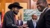 FILE - In this file photo dated June 21, 2018, South Sudan's President Salva Kiir, left, and opposition leader Riek Machar, right, shake hands during peace talks in Addis Ababa, Ethiopia. 