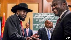 FILE - In this file photo dated June 21, 2018, South Sudan's President Salva Kiir, left, and opposition leader Riek Machar, right, shake hands during peace talks in Addis Ababa, Ethiopia. 