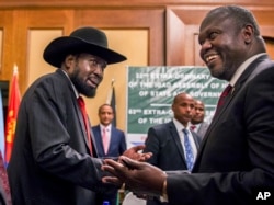 FILE - South Sudan's President Salva Kiir, left, and opposition leader Riek Machar, right, shake hands during peace talks in Addis Ababa, Ethiopia, June 21, 2018.