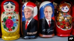 FILE - Traditional Russian wooden dolls depicting U.S. President Donald Trump and Russian President Vladimir Putin are displayed for sale at a street souvenir shop in St. Petersburg, Russia, Jan. 20, 2017.
