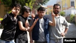 Syrian migrants are pictured in front of the National Reception Center For Asylum Seekers in Tirana, Albania, June 6, 2018. 