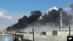 Smoke rises after airstrikes by military jets in Talbiseh, a city in western Syria’s Homs province, where Russia launched airstrikes for the first time, Sept. 30, 2015. The image was made from video provided by Homs Media Center and authenticated by AP. 