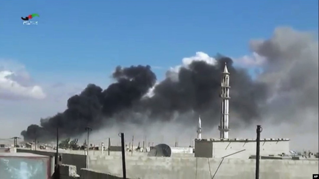 Smoke rises after airstrikes by military jets in Talbisseh, a city in western Syria’s Homs province, where Russia launched airstrikes for the first time, Sept. 30, 2015. The image was made from video provided by Homs Media Center and authenticated by AP.