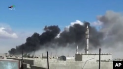 Smoke rises after airstrikes by military jets in Talbisseh, a city in western Syria’s Homs province, where Russia launched airstrikes for the first time, Sept. 30, 2015. The image was made from video provided by Homs Media Center and authenticated by AP.