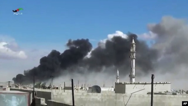 Smoke rises after airstrikes by military jets in Talbiseh, a city in western Syria’s Homs province, where Russia launched airstrikes for the first time, Sept. 30, 2015. The image was made from video provided by Homs Media Center and authenticated by AP.