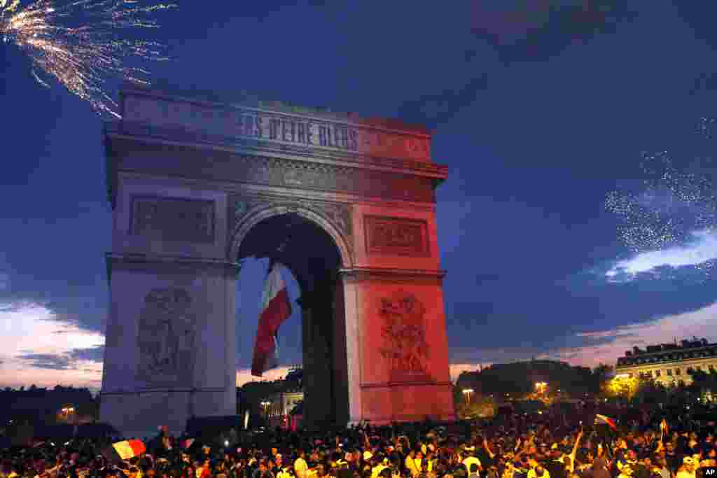 The Arc de Triomphe is lit up with the colors of the French national flag and by fireworks set off by French soccer fans celebrating France's World Cup victory over Croatia, in Paris, France, Sunday, July 15, 2018. 