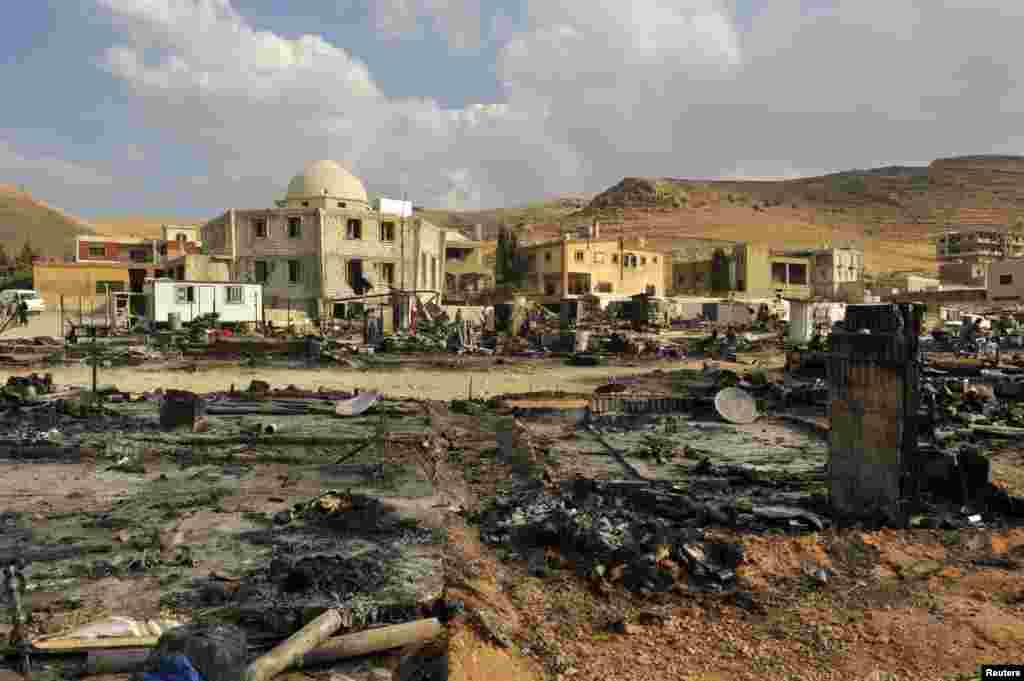 A general view shows damage and burnt tents for Syrian refugees from the fighting between Lebanese army soldiers and Islamist militants in the Sunni Muslim border town of Arsal, in eastern Bekaa Valley, Aug. 7, 2014.