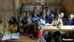 FILE - A class of children between the ages of six and seven years old pose for pictures in their classroom at Gifted Hands Educational Center in Kenya's Kibera neighborhood in the capital Nairobi, September 2015.