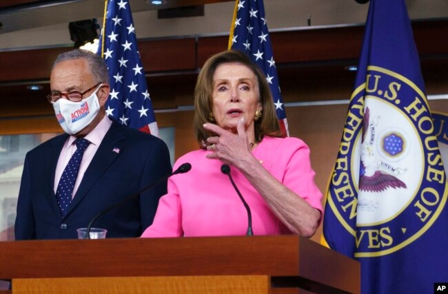 FILE - Speaker of the House Nancy Pelosi, D-Calif., joined by Senate Majority Leader Chuck Schumer, D-N.Y., speaks to reporters at the Capitol in Washington, Sept. 23, 2021,