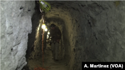 A U.S. Border Patrol agent inspects a tunnel linking Tijuana, Mexico, and the entrance site in San Diego, Calif., March 6, 2017.