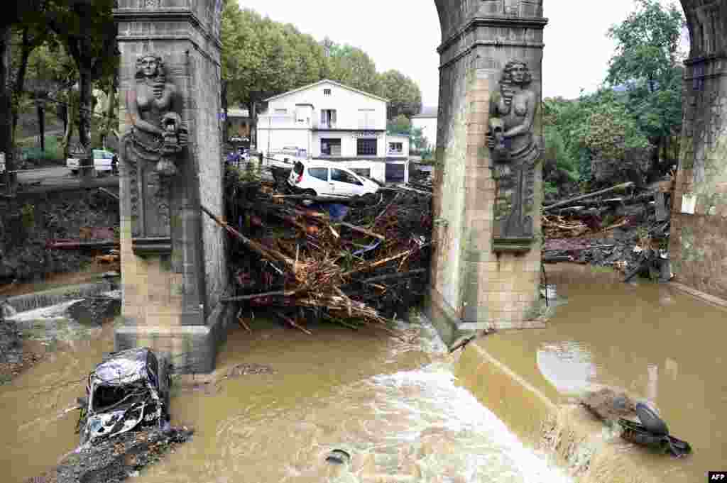 Wood pieces and cars are seen stuck under a bridge over the Bitoulet River in Lamalou-les-Bains, southern France. Five people died when storms turned a peaceful river that bordered their camping site in southern France into an extremely powerful river that swept them away, rescue workers said. 