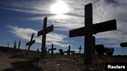 Crosses fill a graveyard in Cape Town's Khayelitsha township February 27, 2010. Many of those buried in the South African cemetery died from AIDS or related complications such as tuberculosis (TB).