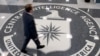 FILE - A man crosses the Central Intelligence Agency (CIA) logo in the lobby of CIA Headquarters in Langley, Virginia.