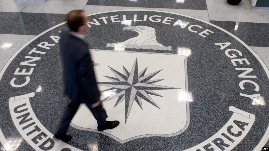 FILE - A man crosses the Central Intelligence Agency logo in the lobby of CIA Headquarters in Langley, Virginia.