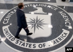 FILE - A man is seen walking across the Central Intelligence Agency (CIA) logo in the lobby of CIA Headquarters in Langley, Virginia, in a 2008 photo). Democrats say Trump will have to rely on intelligence agencies when he becomes commander-in-chief.