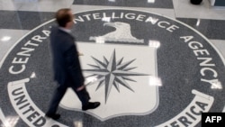 FILE - A man crosses the Central Intelligence Agency (CIA) logo in the lobby of CIA Headquarters in Langley, Virginia.
