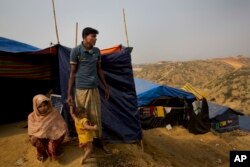 Rohingya Muslim refugee Mohammad Younus, 25, from the Myanmar village of Gu Dar Pyin, stands on a hill of Kutupalong refugee camp, Bangladesh, Jan. 14, 2018.