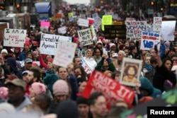 FILE - People participate in the Women's March on Washington, following the inauguration of President Donald Trump, in Washington, D.C., Jan. 21, 2017.