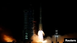 The Long March-2F Y13 rocket, carrying the Shenzhou-13 spacecraft and three astronauts in China's second crewed mission to build its own space station, launches at Jiuquan Satellite Launch Center near Jiuquan, Gansu province, Oct. 16, 2021. 