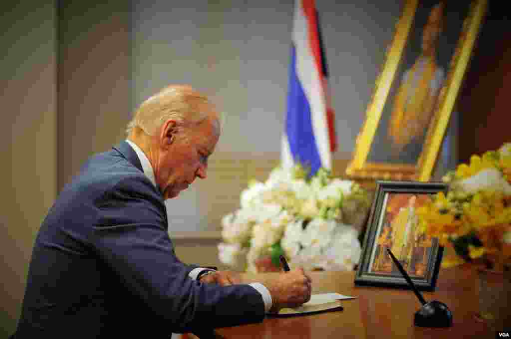 Vice President Joe Biden signs a book of condolences for His Majesty King Bhumibol Adulyadej