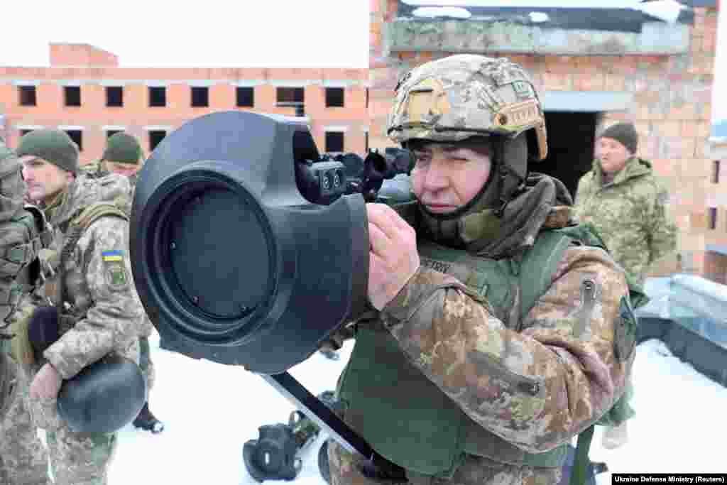 A Ukrainian service member points a next generation light anti-tank weapon (NLAW), supplied by Britain amid tensions between Russia and the West over Ukraine, during drills in the Lviv region.