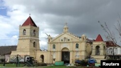 DOSSIER - In Balangiga, the Roman Catholic belfry burst from the rubble, a symbol of resistance for a people with mixed feelings about the US military that helps them survive. The city built the bell tower in 1998 in the hope that the United States would make three bells, trophies won during the Philippine-American War of 1899-1902. Photo taken on November 20, 2013.