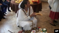 Anyalem Barayes prepares to conduct a traditional Eritrean coffee service.