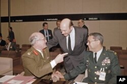FILE - United Kingdom Chief of Staff Field Marshall Sir Richard Vincent, left, with NATO Secretary General Manfred Woerner and U.S. Chief of Staff Gen. Colin Powell, right, at the NATO Defense Minister meeting in Belgium, Dec. 12, 1991.