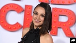 FILE - Mila Kunis arrives at the Los Angeles premiere of "A Bad Moms Christmas," Oct. 30, 2017. Kunis has been named Woman of the Year by Harvard University's Hasty Pudding Theatricals. 