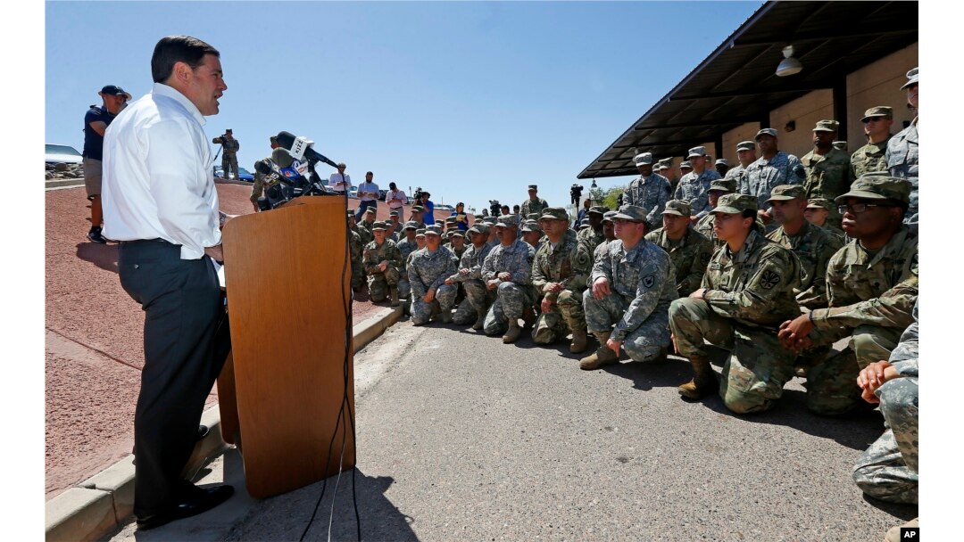 Arizona Republican Gov. Doug Ducey speaks to Arizona National Guard soldiers prior to deployment to the Mexico border at the Papago Park Military Reservation in Phoenix, April 9, 2018.