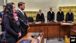 Suspect Beate Zschaepe (L) stands beside her lawyer Mathias Grasel (2nd-L) before Presiding Judge Manfred Goetzl, second from right, speaks the verdict in the court in Munich, southern Germany, July 11, 2018. 