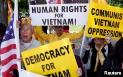 FILE - Vietnamese Americans protest outside the White House before U.S. President Donald Trump's meeting with Vietnamese Prime Minister Nguyen Xuan Phuc at the White House in Washington.