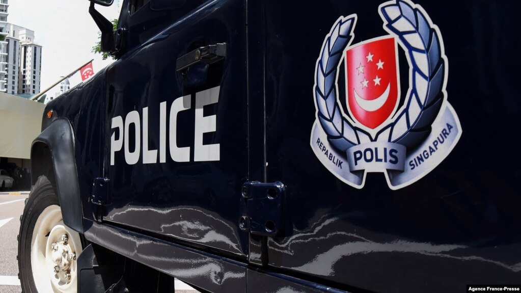 FILE - A police vehicle is seen parked on a street in Singapore, May 31, 2019.