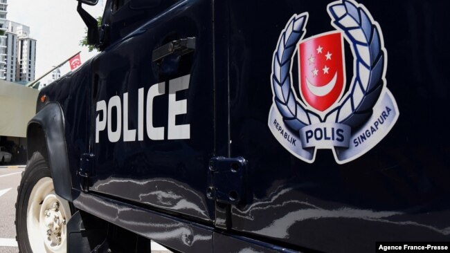 FILE - A police vehicle is seen parked on a street in Singapore, May 31, 2019.