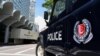 FILE - A police vehicle is seen parked on a street in Singapore, May 31, 2019.